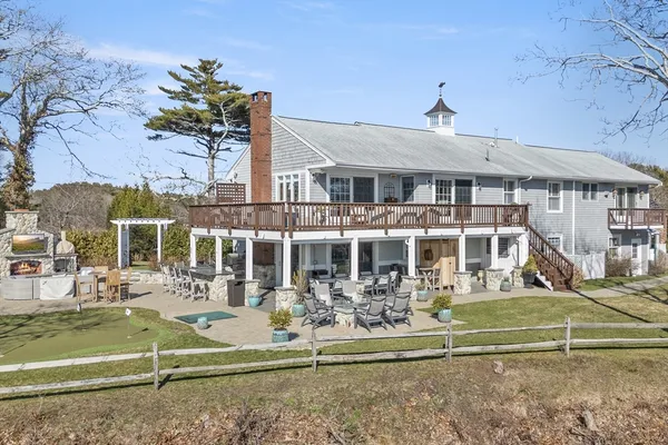 a view of a white house with a yard and furniture