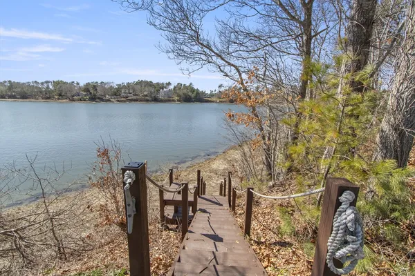 a view of a swimming pool with couches and wooden floor