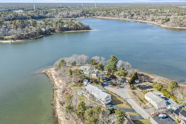 an aerial view of a houses with a lake view