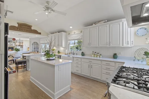 a kitchen with stainless steel appliances a stove a sink and a refrigerator