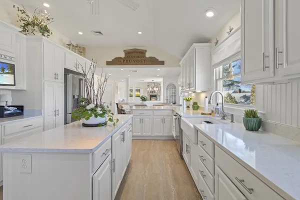 a kitchen with cabinets a sink and appliances