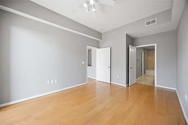 a view of an empty room with wooden floor