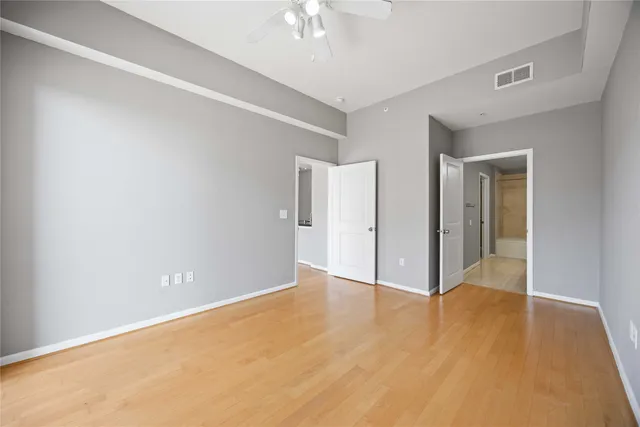 a view of an empty room with wooden floor