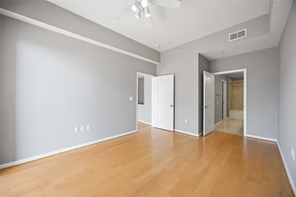 a view of an empty room with wooden floor