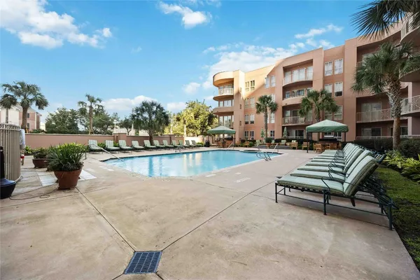 a swimming pool with outdoor seating and yard