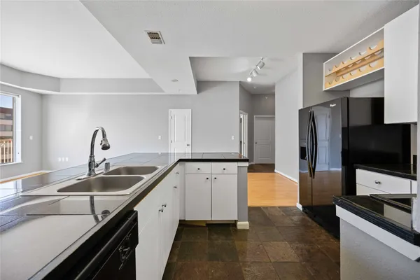 a kitchen with a sink and stainless steel appliances