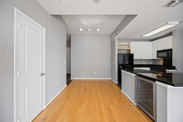 a kitchen with stainless steel appliances granite countertop a refrigerator and a stove top oven