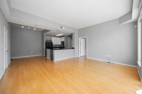a view of a kitchen with a sink and a refrigerator