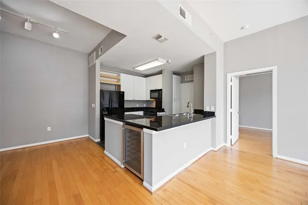 a kitchen with stainless steel appliances kitchen island granite countertop a stove and a refrigerator