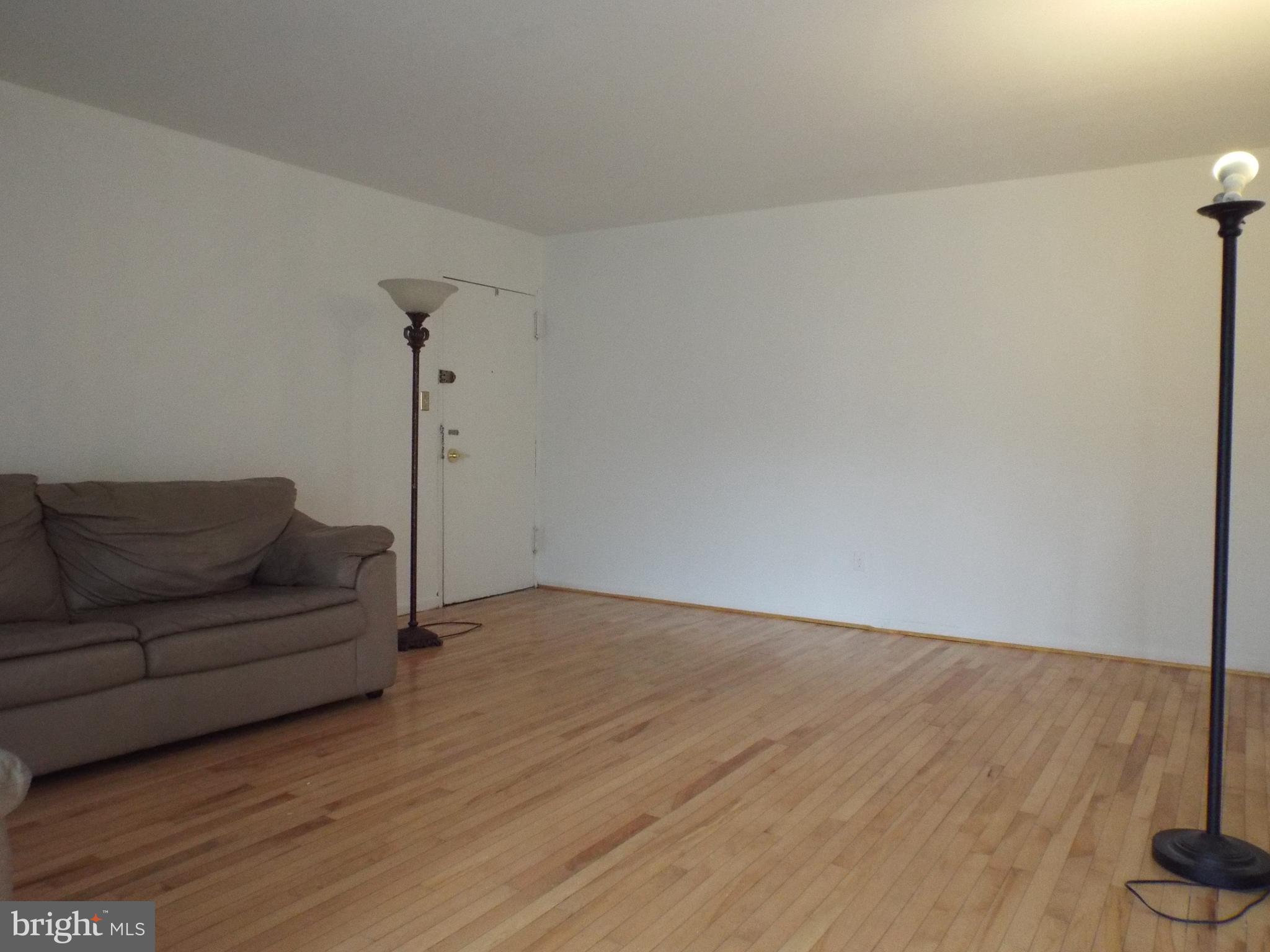 8616 Manchester Road, Unit 5 Silver Spring, MD 20901 - Photo 3 of 16 a living room with furniture and a wooden floor