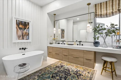 a spacious bathroom with a tub sink and mirror