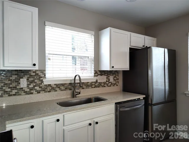 a kitchen with a sink and refrigerator