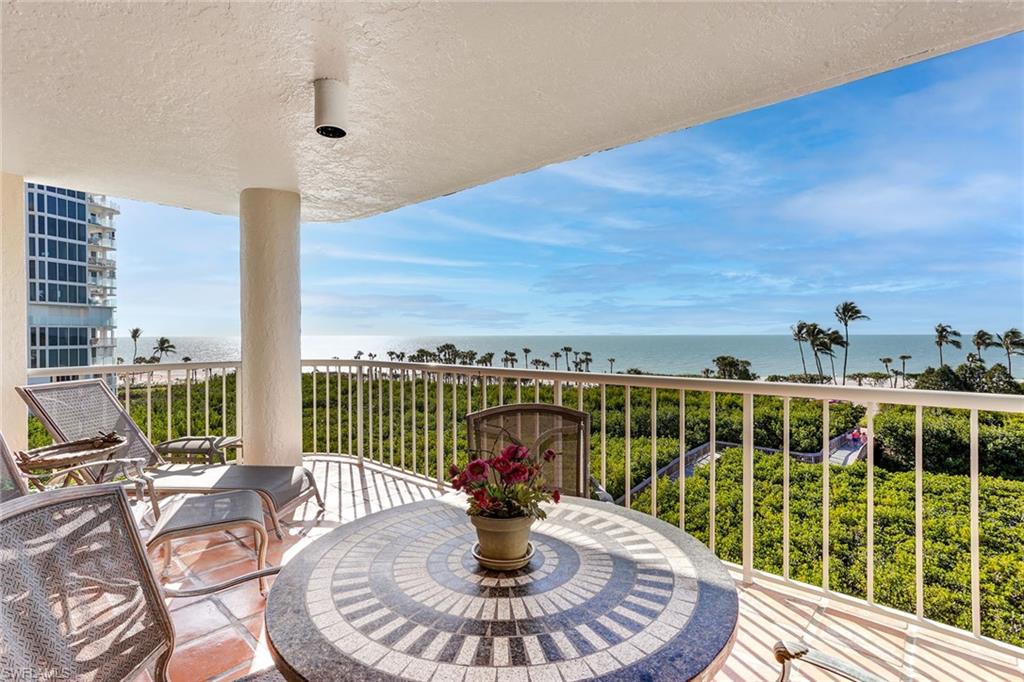 a view of a balcony with lake view and a floor to ceiling window