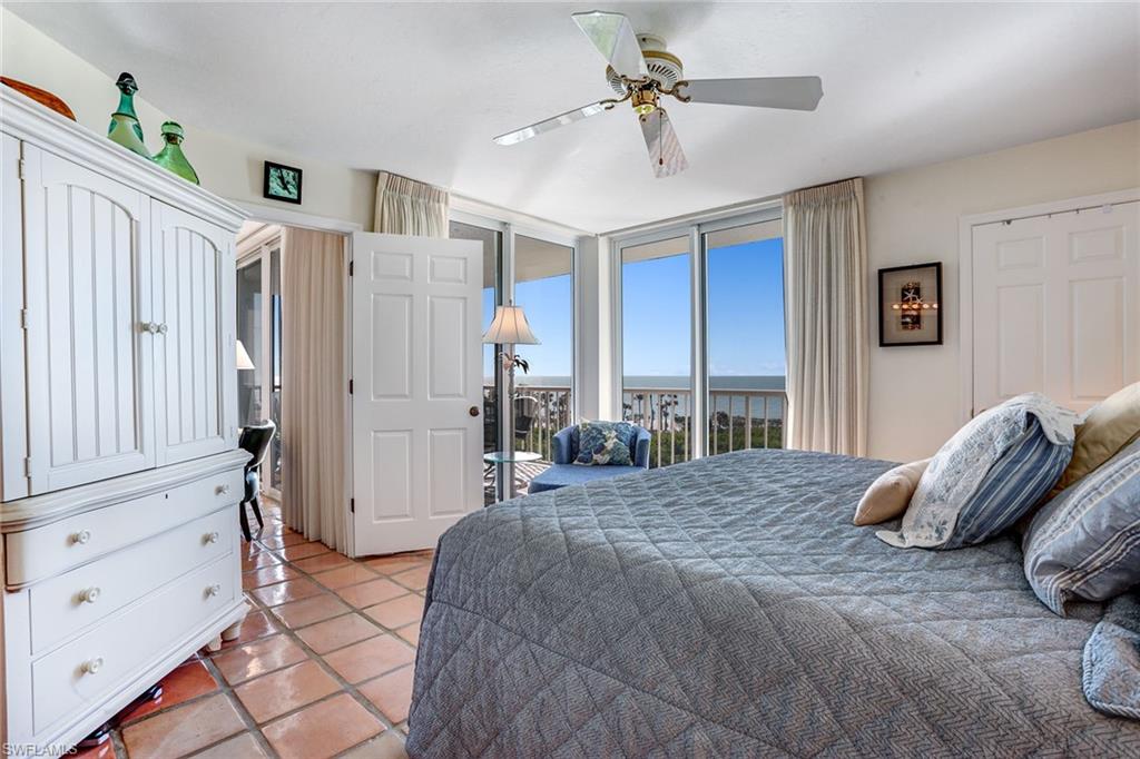 50 Seagate Drive, Unit 402B Naples, FL 34103 - Photo 11 of 26 a bedroom with a large bed and a window