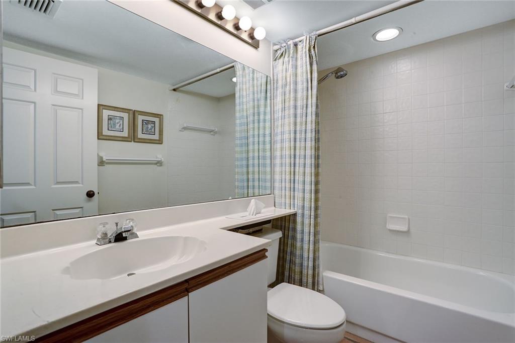 50 Seagate Drive, Unit 402B Naples, FL 34103 - Photo 15 of 26 a bathroom with a sink toilet tub and shower