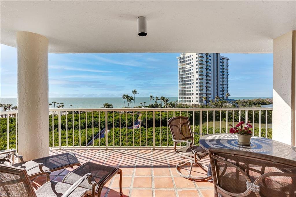 50 Seagate Drive, Unit 402B Naples, FL 34103 - Photo 18 of 26 a view of a balcony with two chairs and a table