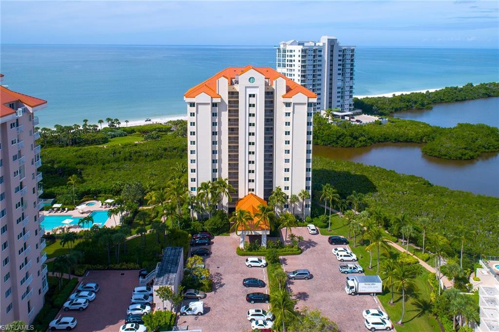 50 Seagate Drive, Unit 402B Naples, FL 34103 - Photo 23 of 26 an aerial view of a house with a yard and lake view