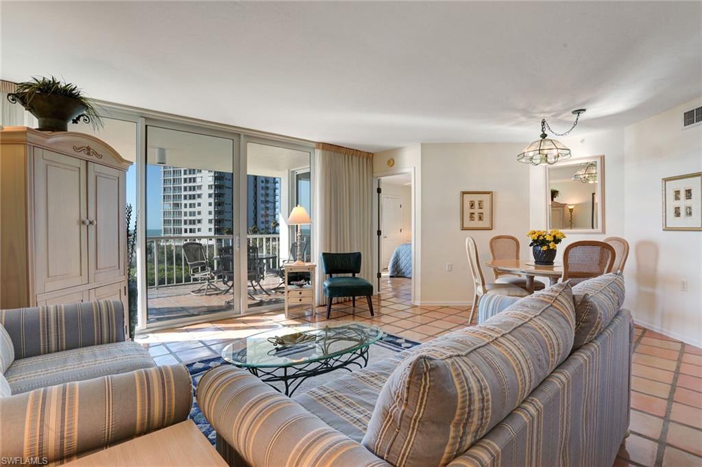 50 Seagate Drive, Unit 402B Naples, FL 34103 - Photo 3 of 26 a living room with furniture and a large window