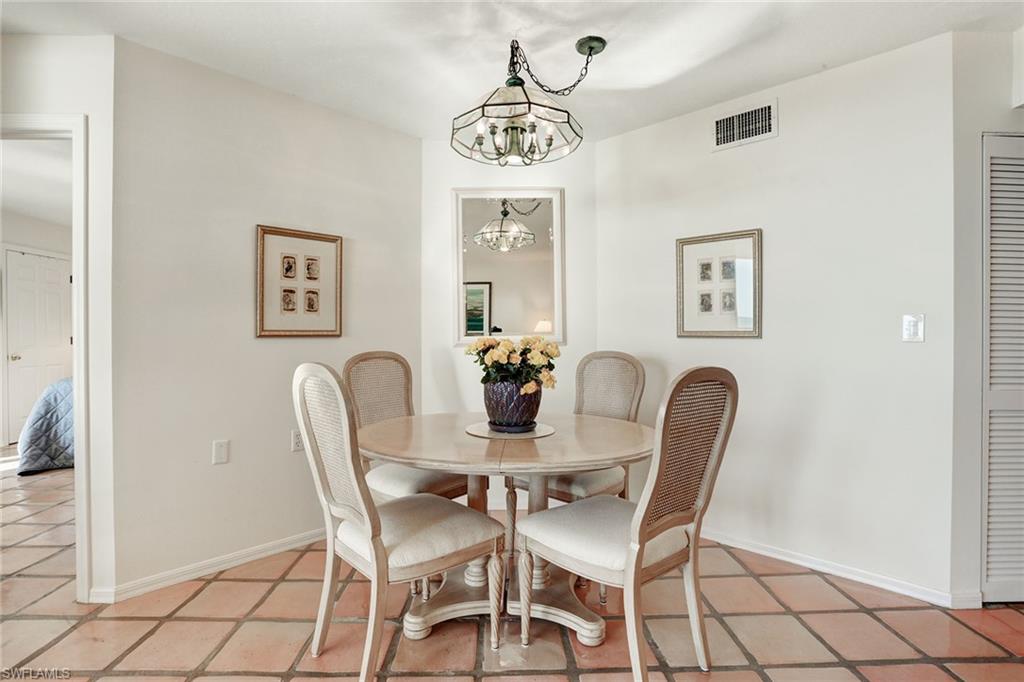 50 Seagate Drive, Unit 402B Naples, FL 34103 - Photo 9 of 26 a dining room with furniture and window