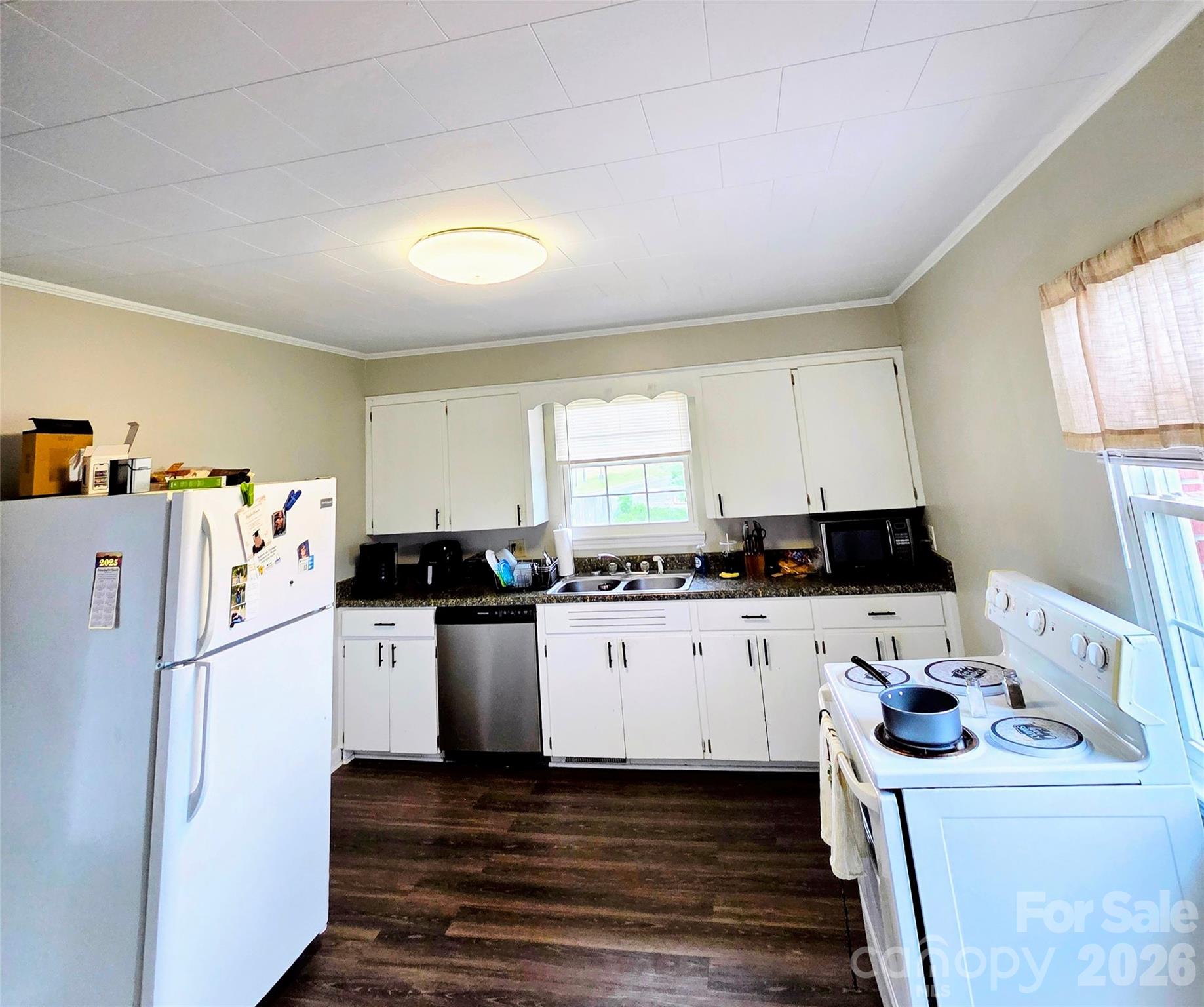 613 Judy Street Albemarle, NC 28001 - Photo 5 of 15 a kitchen with granite countertop a refrigerator a sink a stove and white cabinets