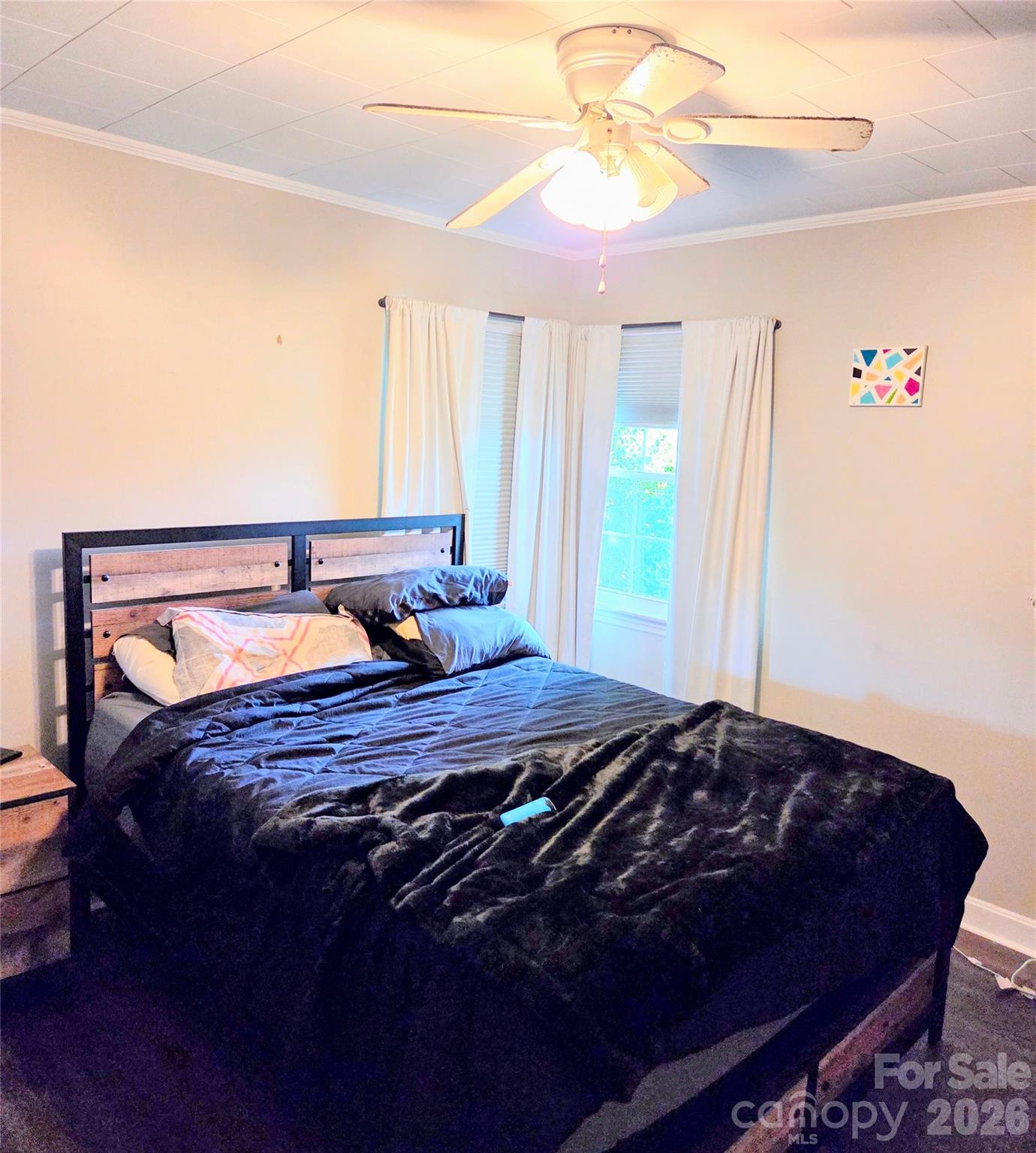 613 Judy Street Albemarle, NC 28001 - Photo 10 of 15 a bedroom with a bed and a chandelier