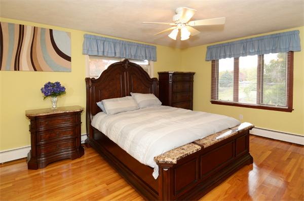 32 Pickman Road Salem, MA 01970 - Photo 19 of 26 a bedroom with a bed and a chandelier