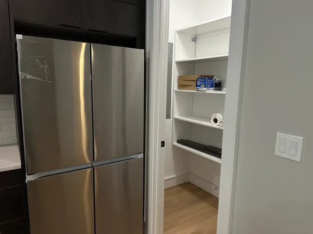 a view of walk in closet with empty racks