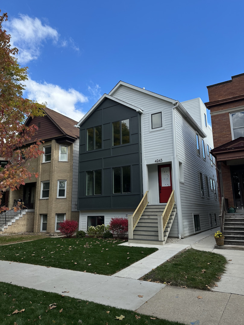 4243 North Damen Avenue, Unit 1F Chicago, IL 60618 - Photo 2 of 42 a front view of a house with a yard