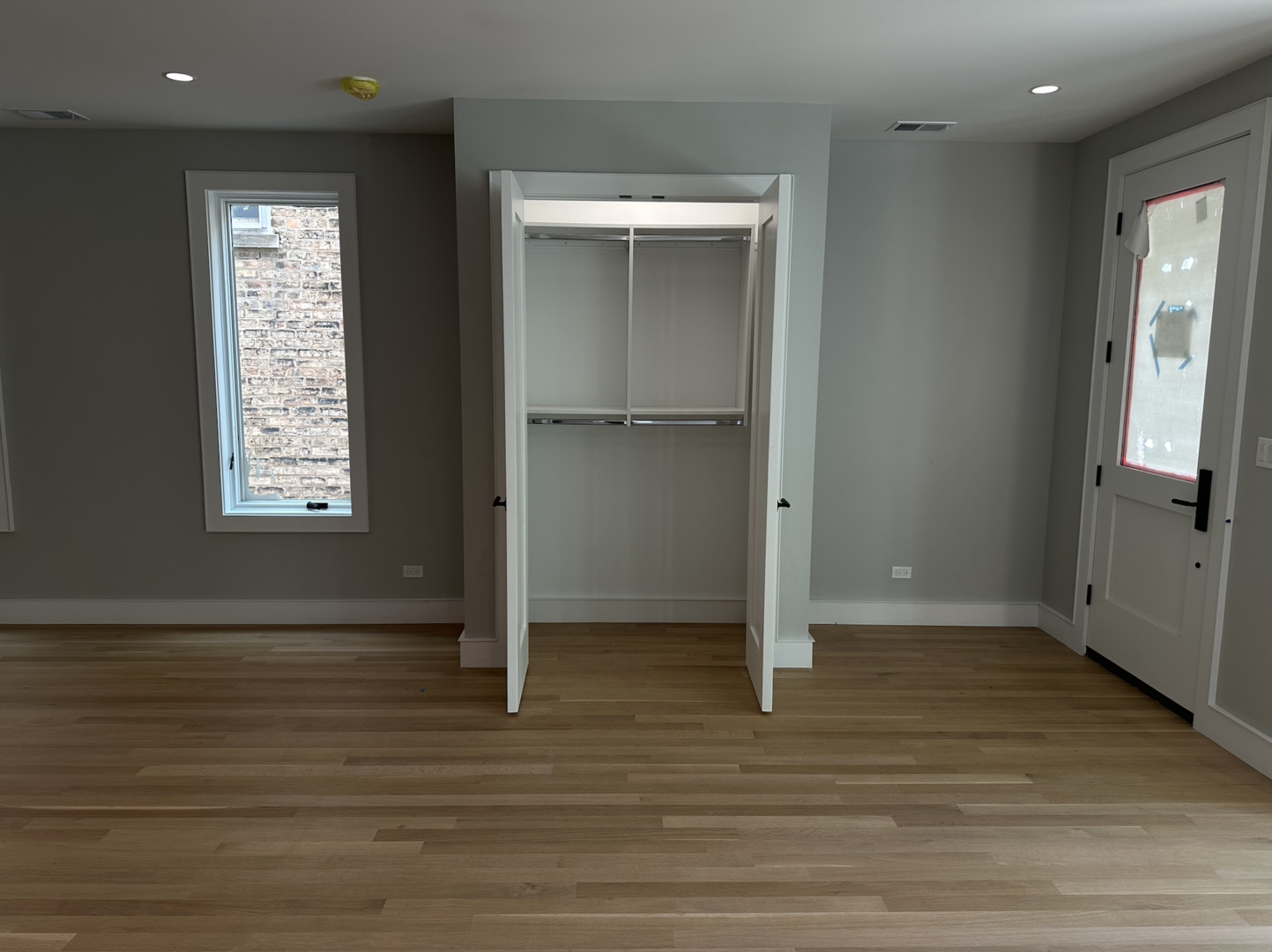 4243 North Damen Avenue, Unit 1F Chicago, IL 60618 - Photo 4 of 42 an empty room with wooden floor closet and windows