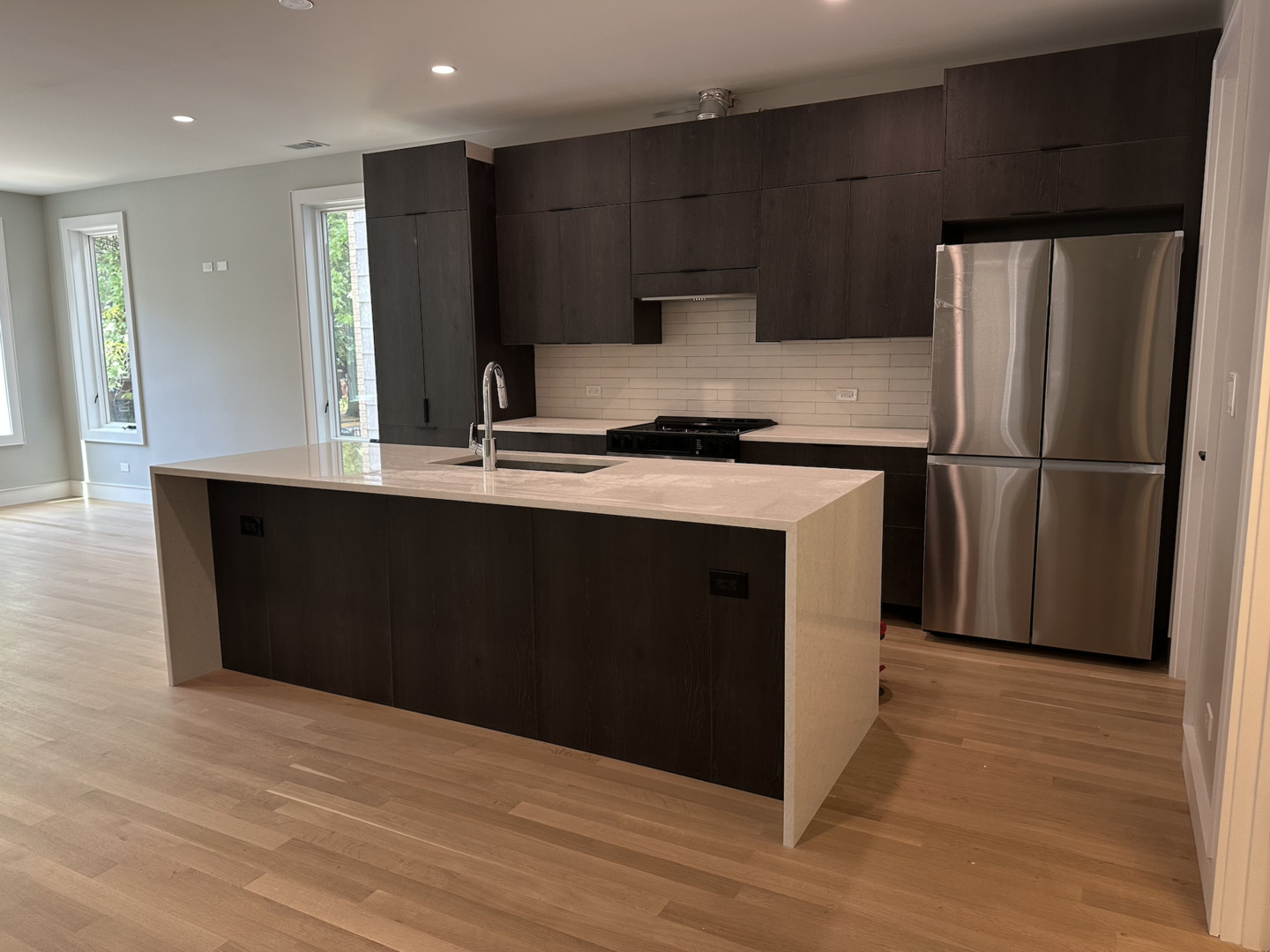 4243 North Damen Avenue, Unit 1F Chicago, IL 60618 - Photo 8 of 42 a kitchen with kitchen island a counter top space cabinets and stainless steel appliances