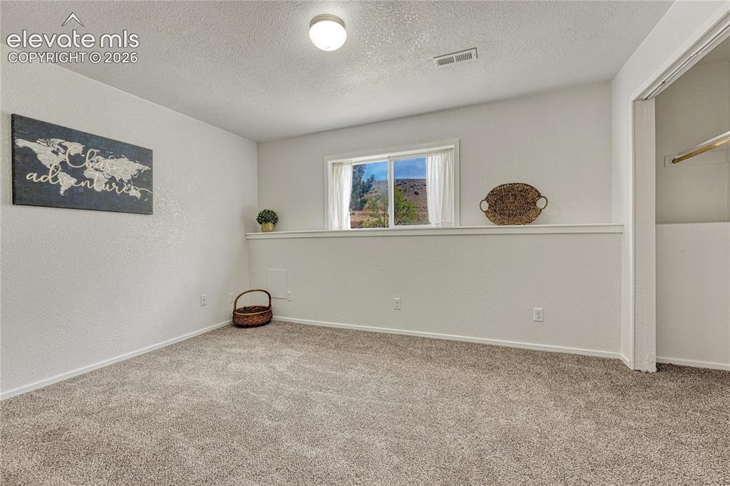 7285 Julynn Road Colorado Springs, CO 80919 - Photo 33 of 45 an empty room with windows