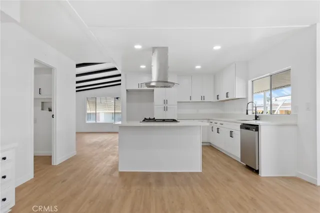 a kitchen with stainless steel appliances a sink and a stove
