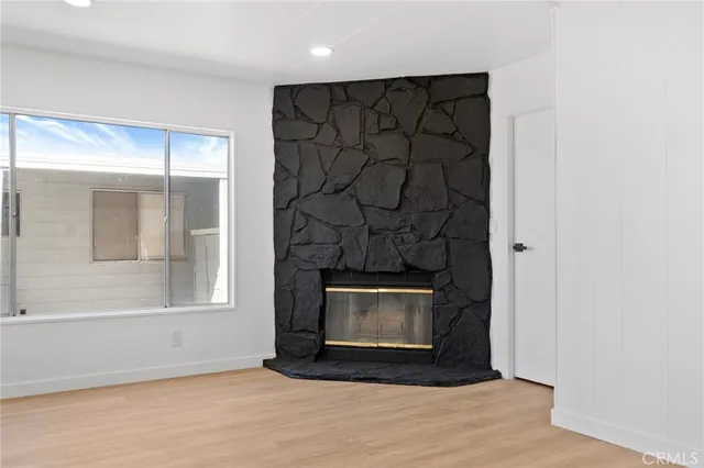 a view of a room with wooden floor and a ceiling fan