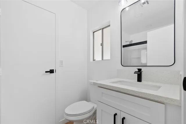 an empty room with wooden floor and a window