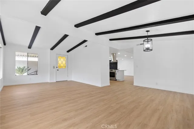 a view of a hallway with wooden floor and cabinet