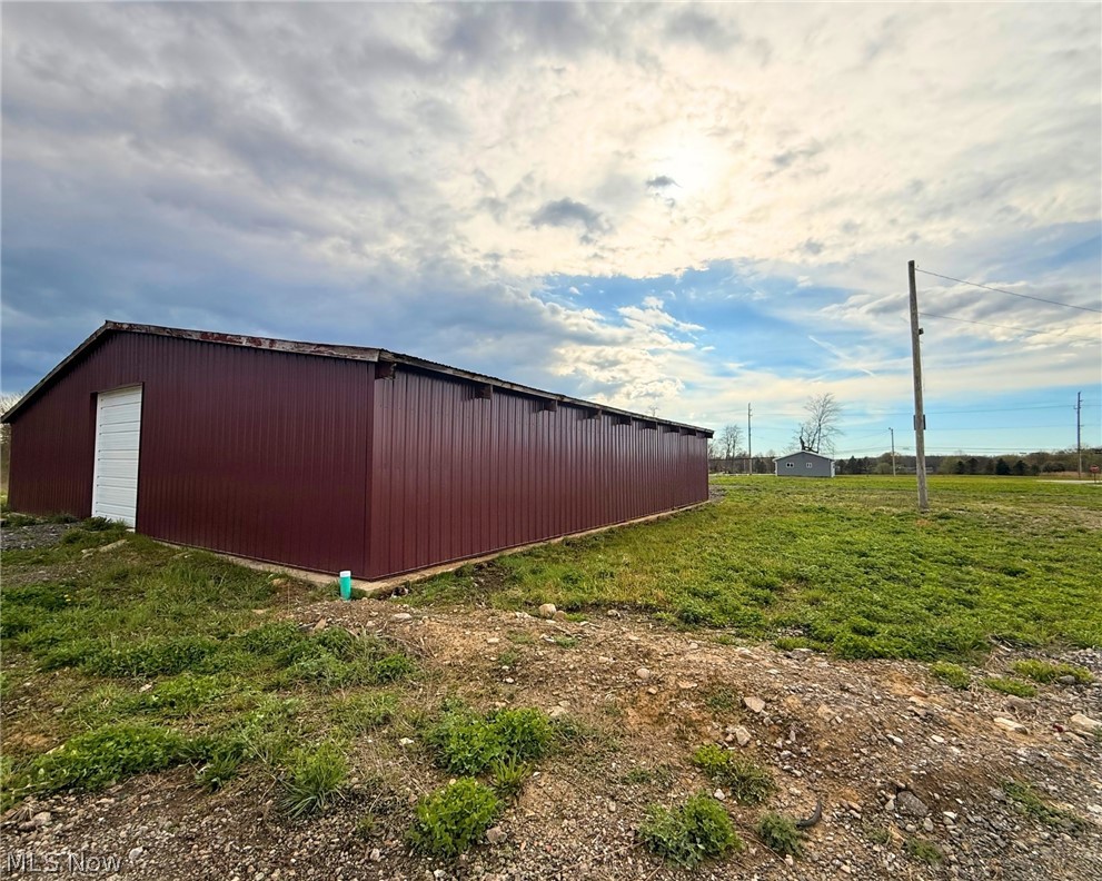 4772 Highway 45 Rome, OH 44085 - Photo 21 of 38 Expansive metal-sided structure featuring a pitched roofline, white entry door, and multiple upper-level openings