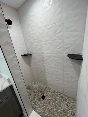 a view of a storage & utility room with a washing machine