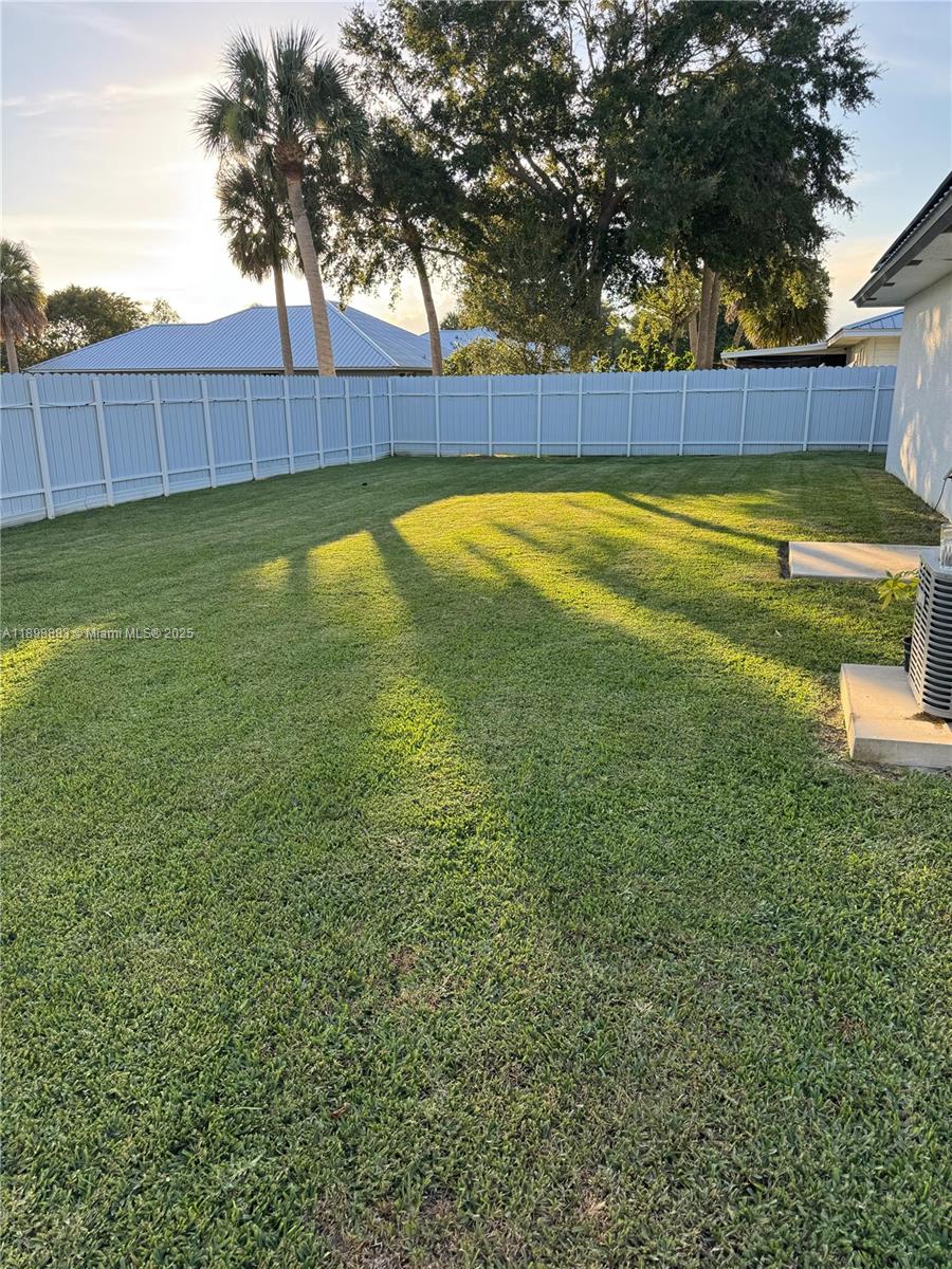 5218 Southeast 43rd Street Okeechobee, FL 34974 - Photo 14 of 20 a view of a swimming pool with a small yard and wooden fence