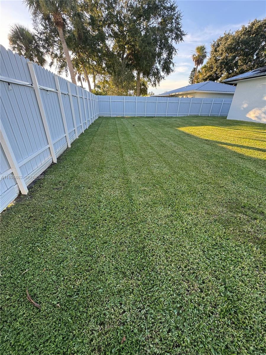 5218 Southeast 43rd Street Okeechobee, FL 34974 - Photo 15 of 20 a view of yard with swimming pool and wooden fence