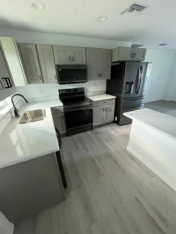 a kitchen with a sink and appliances