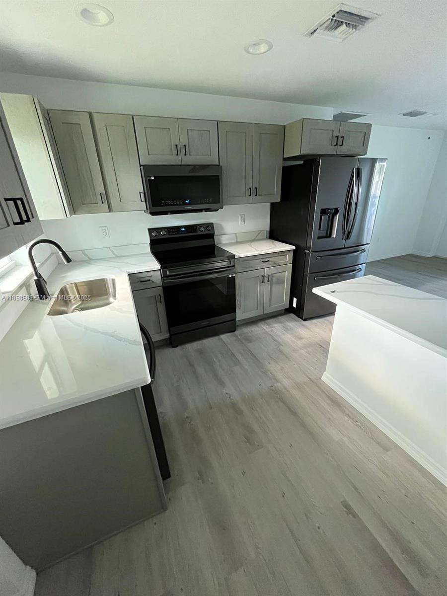 5218 Southeast 43rd Street Okeechobee, FL 34974 - Photo 2 of 20 a kitchen with a sink and appliances