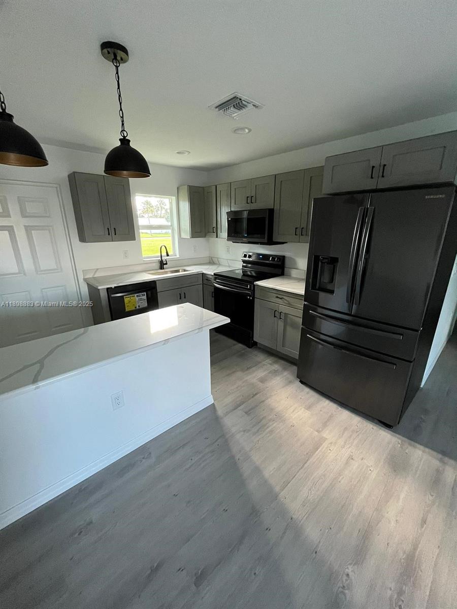 5218 Southeast 43rd Street Okeechobee, FL 34974 - Photo 8 of 20 a living room with furniture and a flat screen tv