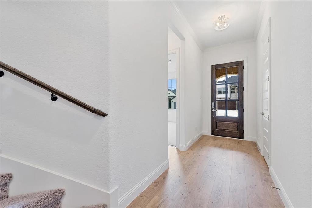 9337 Loggerhead Way Fort Worth, TX 76118 - Photo 4 of 40 a view of a hallway with wooden floor and entryway