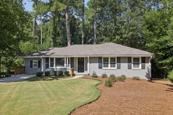 a front view of a house with swimming pool and porch