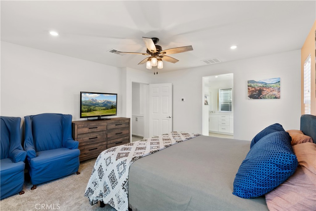 904 Maya Crossing, Unit 19 Lake Elsinore, CA 92530 - Photo 12 of 25 a bedroom with furniture and a flat screen tv