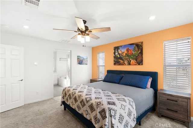 a bedroom with a large bed and a chandelier