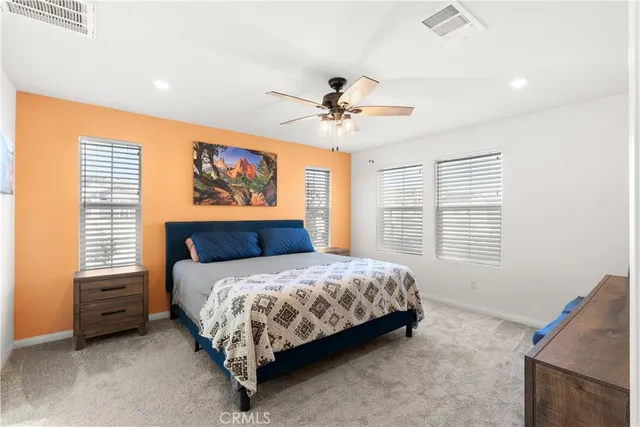 a bedroom with a bed dresser and a window