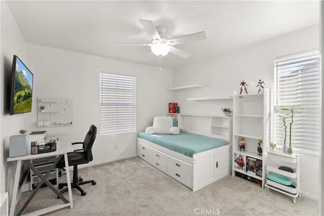 a bedroom with a bed and a desk