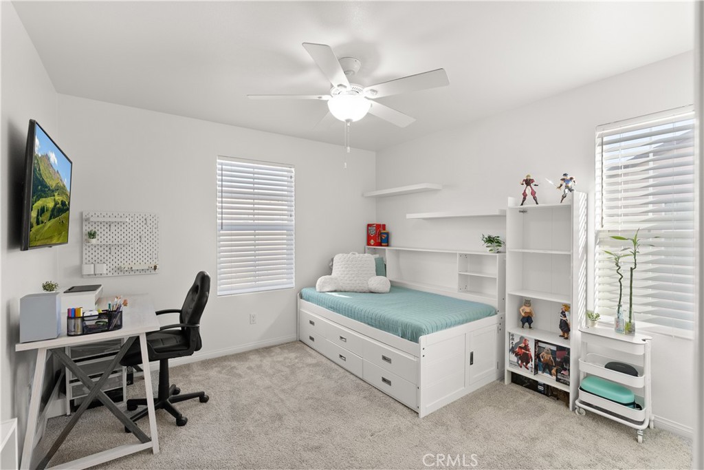 904 Maya Crossing, Unit 19 Lake Elsinore, CA 92530 - Photo 17 of 25 a bedroom with a bed and a desk