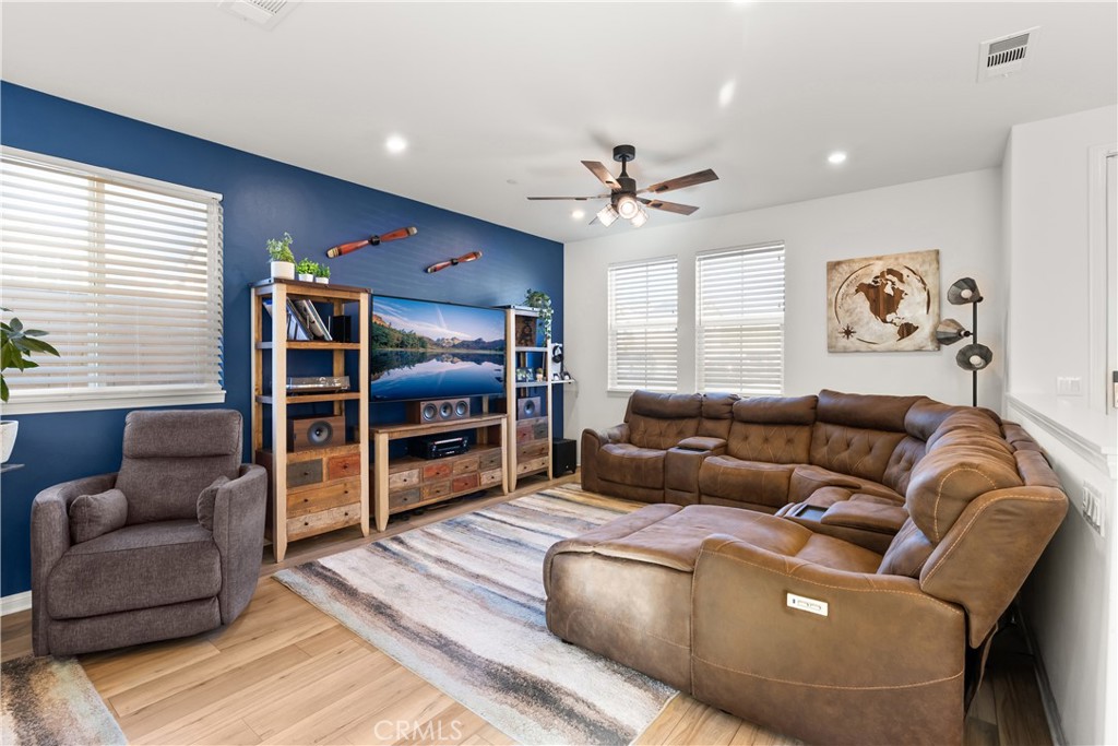 904 Maya Crossing, Unit 19 Lake Elsinore, CA 92530 - Photo 2 of 25 a living room with furniture and a flat screen tv